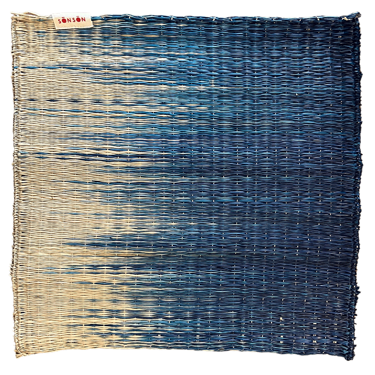 A beautifully crafted weaving mat featuring a serene ombre design that transitions from deep navy to soft sky blue, perfect for adding a touch of tranquility to any space.